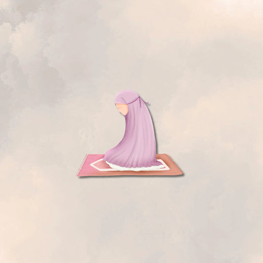 young girl praying on prayer mat