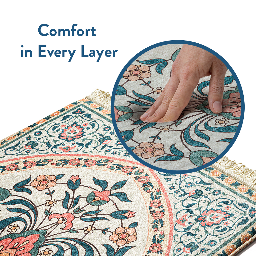 Close-up of hand pressing into padded adult prayer mat with teal and coral floral design by urban rugs uk