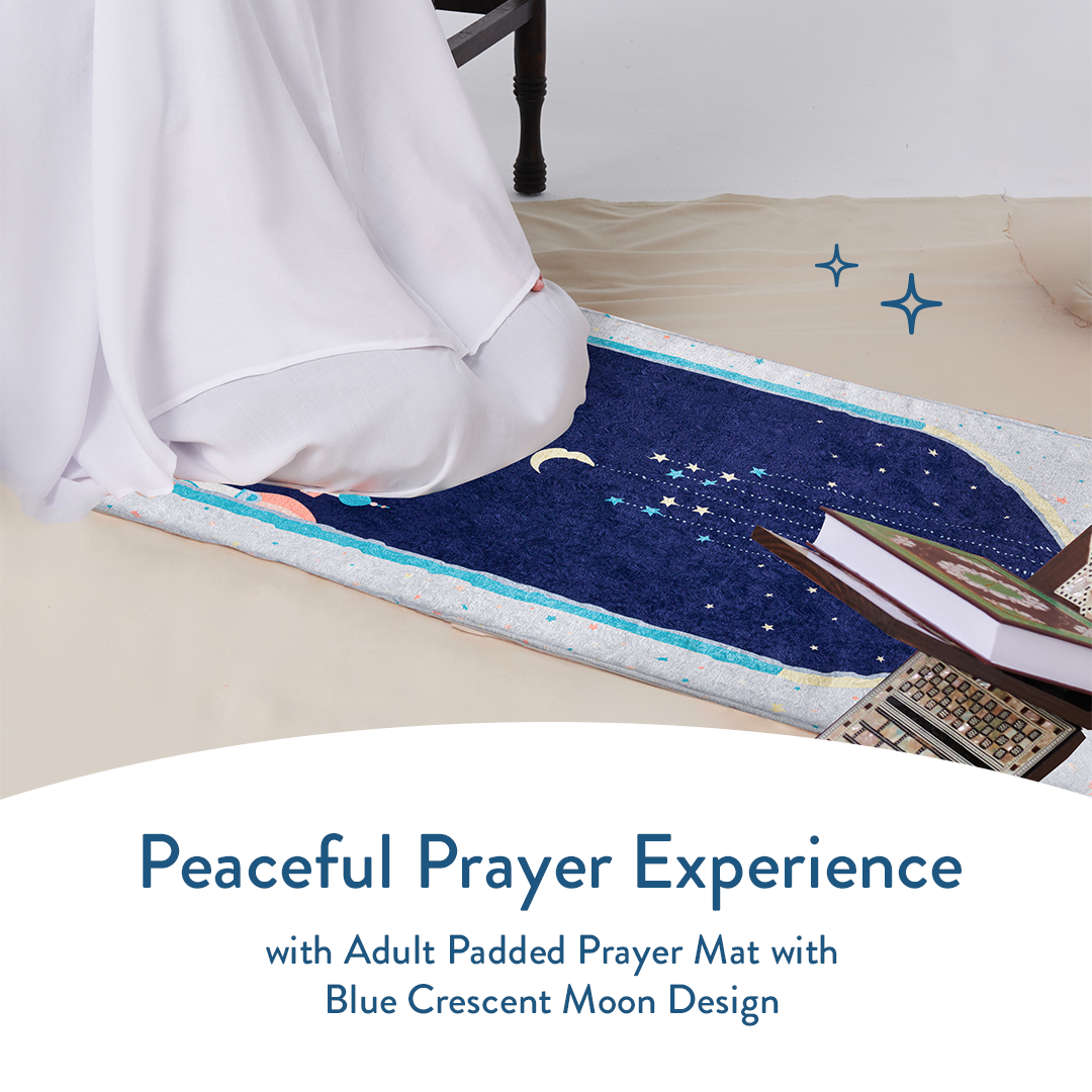 Person praying on padded prayer mat with blue crescent moon design from Urban Rugs UK.
