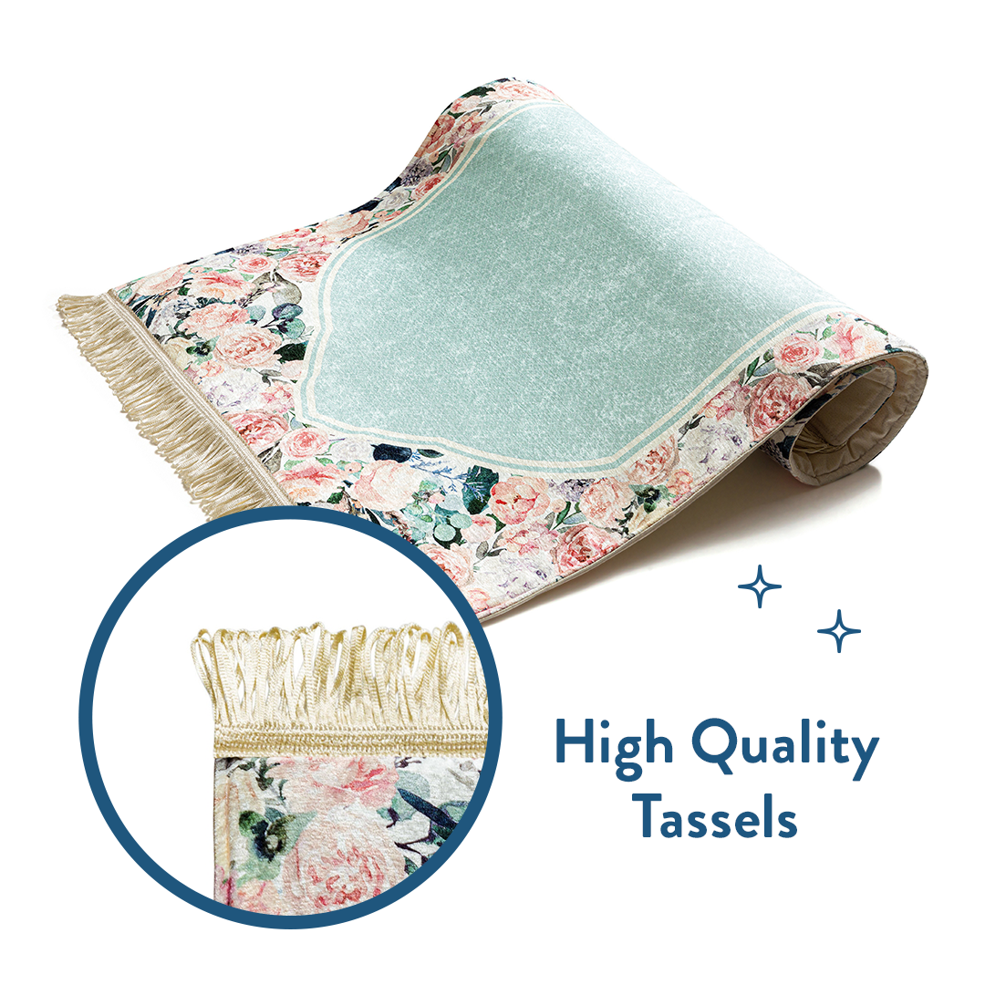 Folded floral padded prayer mat with close-up of high quality tassels by urban rugs uk