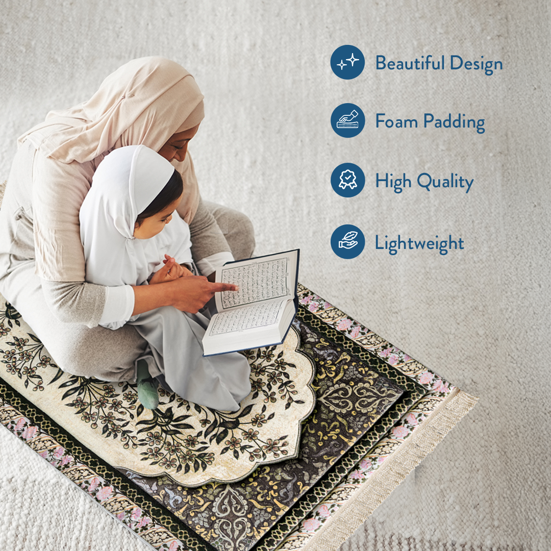 mother and daughter reading Qur’an on padded prayer mat with vintage botanical design