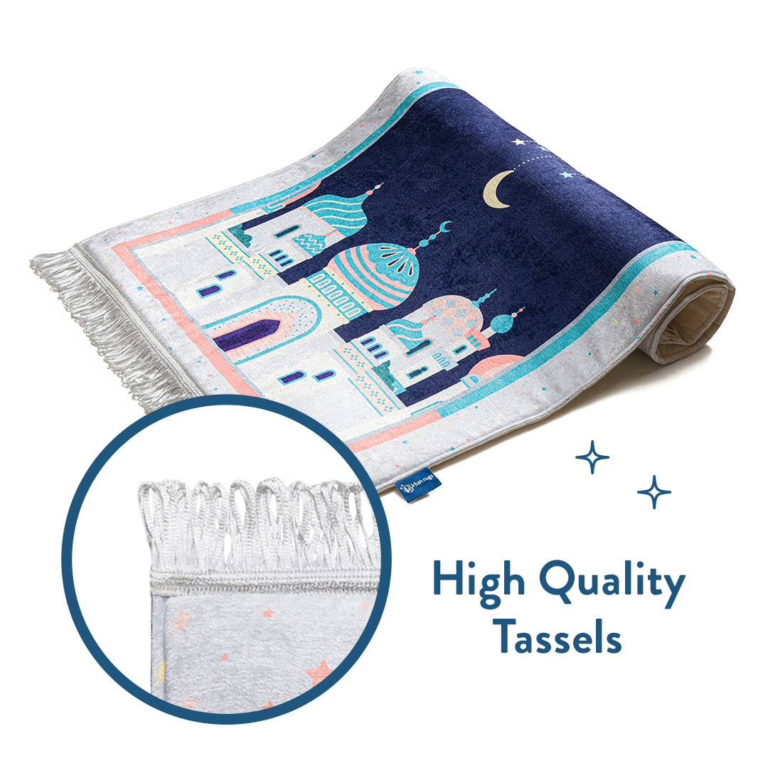 Folded floral padded prayer mat with close-up of high quality tassels by urban rugs uk