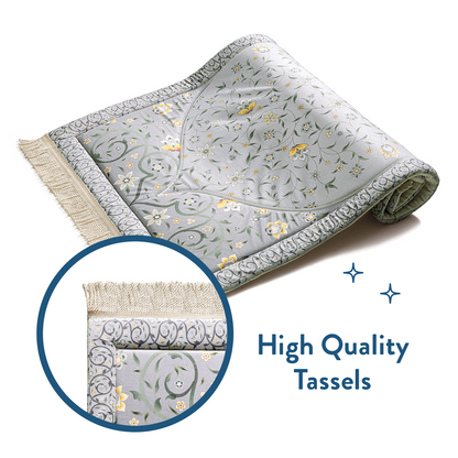 Folded floral padded prayer mat with close-up of high quality tassels by Urban Rugs UK